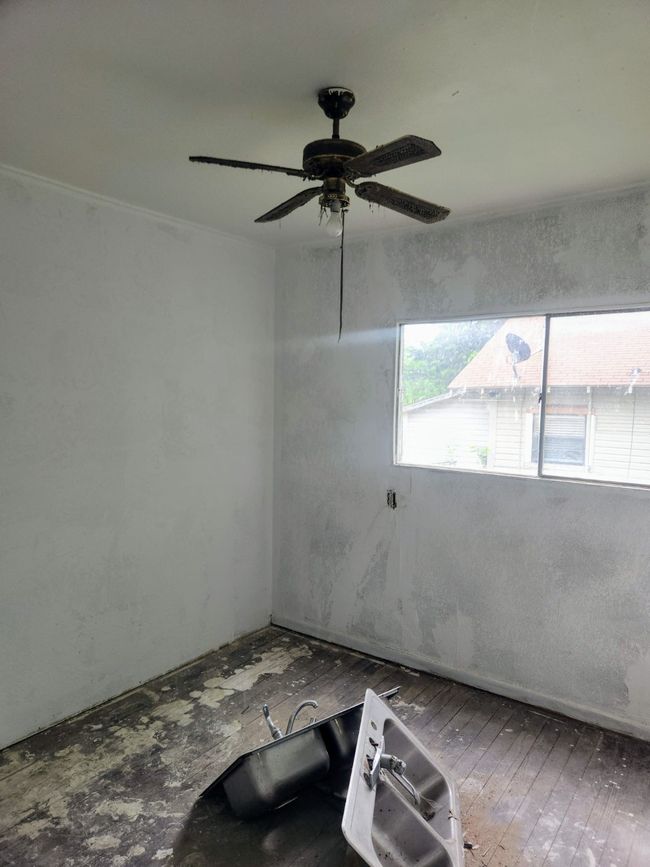 Empty room featuring wood-type flooring and ceiling fan | Image 9