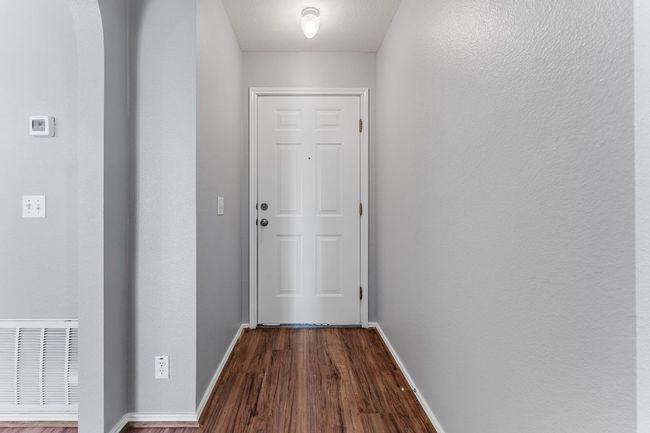 Entryway with baseboards and dark wood finished floors | Image 17