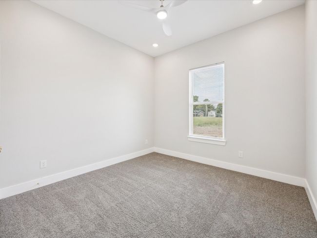 Carpeted spare room featuring a ceiling fan and recessed lighting | Image 22
