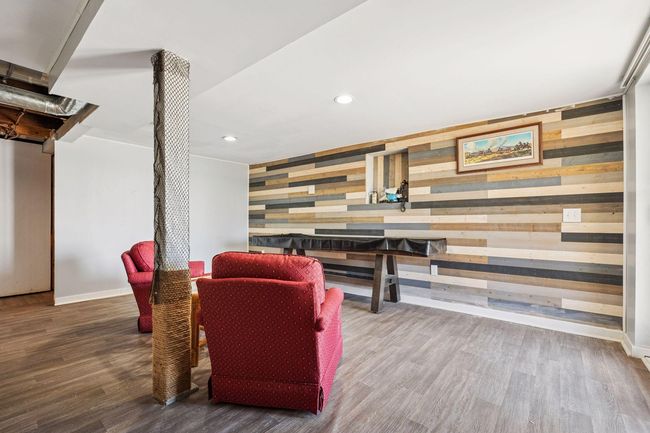 Another view of the family room highlights the cozy accent wall, adding a warm and inviting touch to the space. | Image 14