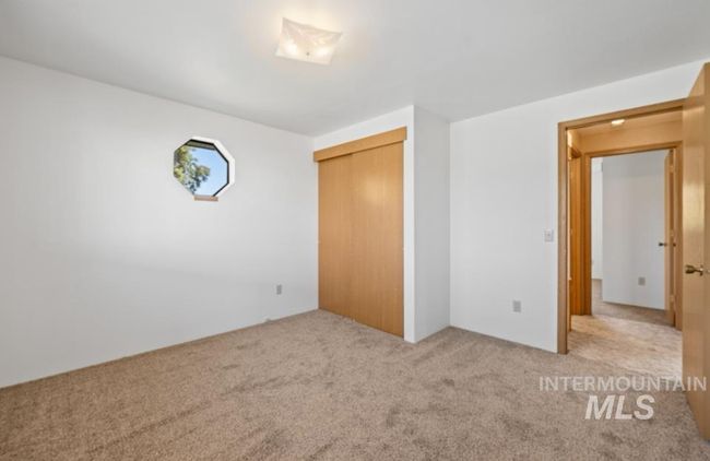 Unfurnished bedroom with carpet and a closet | Image 19