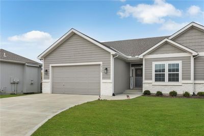 View of front of house with a front yard and a garage | Image 1