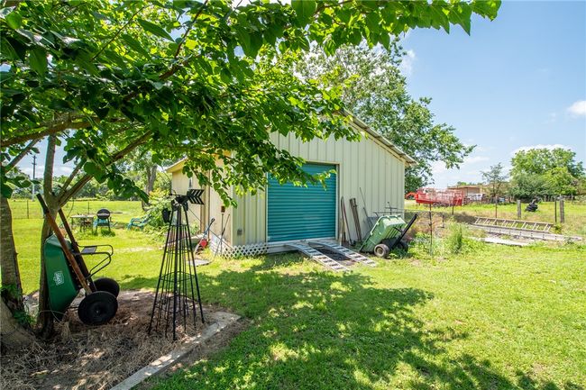 View of yard featuring an outbuilding and a detached garage | Image 39