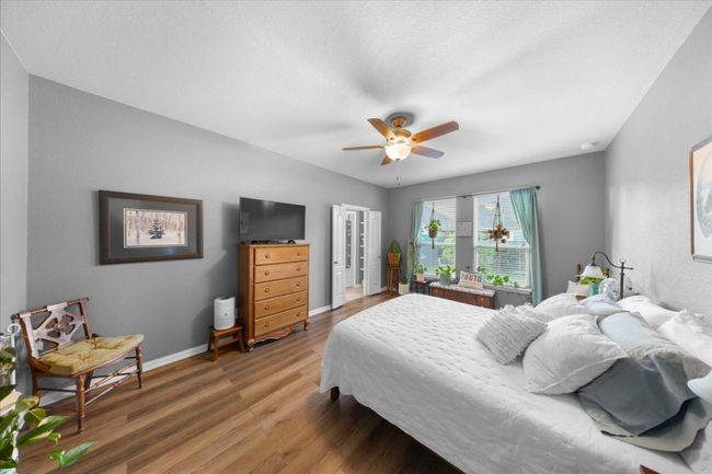 Bedroom with wood finished floors and a ceiling fan | Image 8
