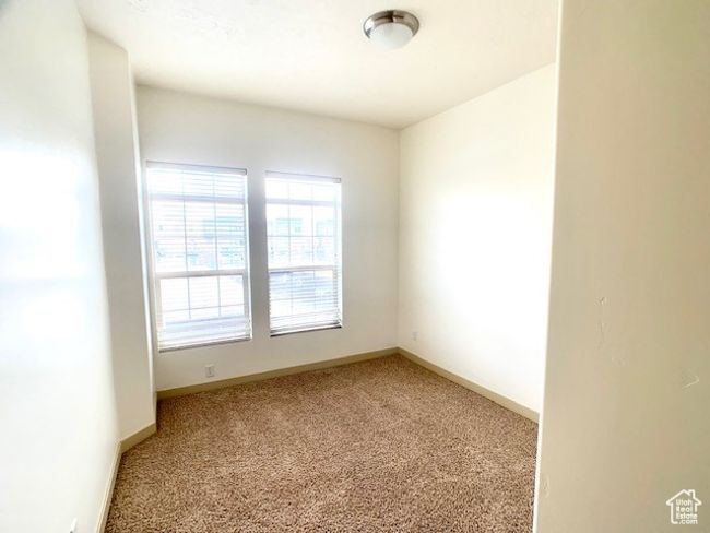 Spare room featuring light colored carpet and baseboards | Image 8