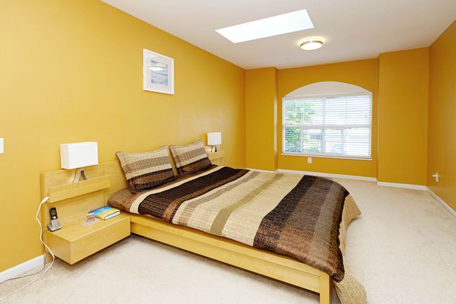 Bedroom with a skylight, light colored carpet, and baseboards | Image 18