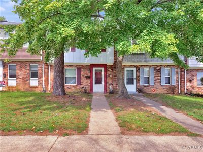 Townhome / multi-family property with a front yard | Image 1