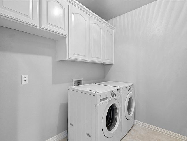 Laundry room with cabinet space and washing machine and clothes dryer | Image 19