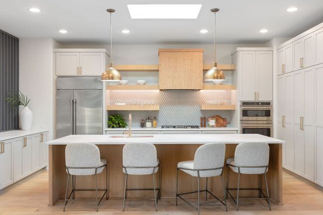 Kitchen with open shelves, a sink, light wood-style floors, appliances with stainless steel finishes, and a skylight | Image 19