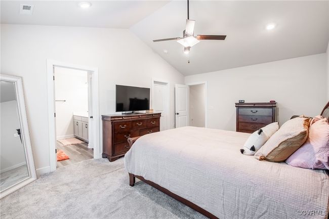 Bedroom with vaulted ceiling, light carpet, connected bathroom, a ceiling fan, and recessed lighting | Image 19