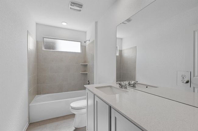 Bathroom with vanity, wood finished floors, and bathing tub / shower combination | Image 19