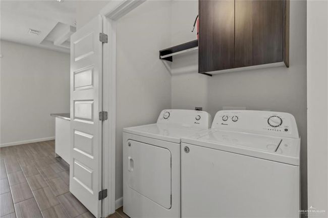 Laundry room with washing machine and clothes dryer and cabinet space | Image 10