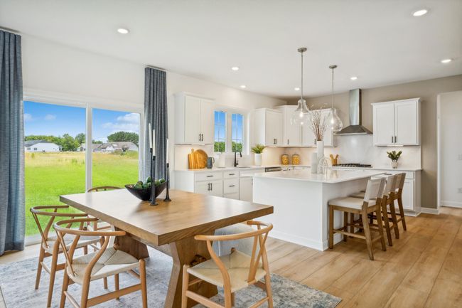 Photo is of the actual model. Soaked in natural sunlight, the homes eat-in dining room has ample space for a dining table located in the heart of the home. | Image 4