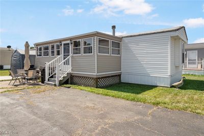 Manufactured / mobile home with a patio area and a front lawn | Image 1