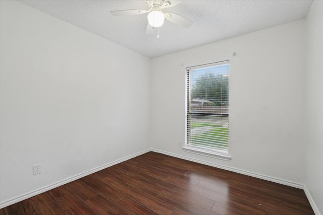 Spare room featuring wood finished floors and a ceiling fan | Image 20