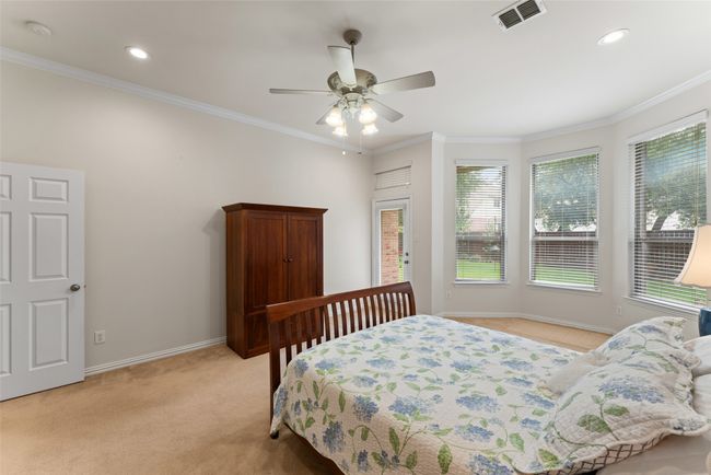 Bedroom with light colored carpet, ornamental molding, recessed lighting, and a ceiling fan | Image 17
