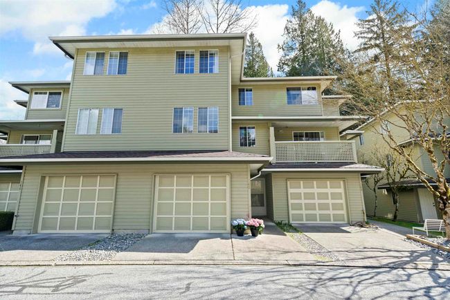 View of front of home featuring an attached garage, driveway, and a balcony | Image 4