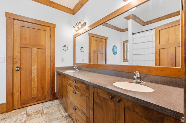 Bathroom with ornamental molding, vanity, and a shower with shower curtain | Image 22