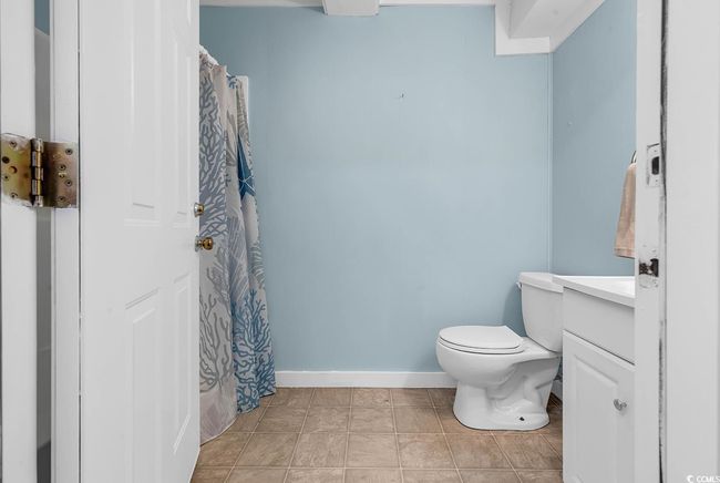 Bathroom featuring baseboards, toilet, vanity, and a tub/shower | Image 29