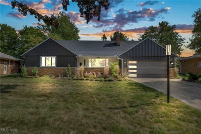 View of front facade featuring a garage, a porch, and a yard | Image 1