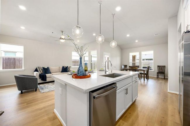 An abundance of natural lighting for the kitchen-dining-living room areas | Image 10