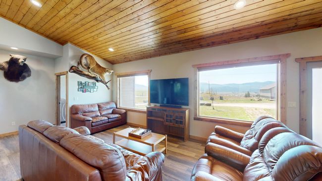 Living room featuring wood ceiling, wood finished floors, vaulted ceiling, and baseboards | Image 10