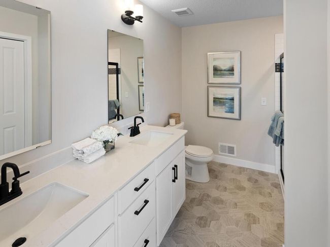 Relax and unwind in the stylish en-suite, featuring a spacious 5' tiled shower and a convenient linen closet, offering both elegance and practicality in a tranquil setting. | Image 25