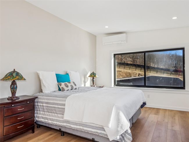 Charming bedroom offering serene pasture views | Image 12