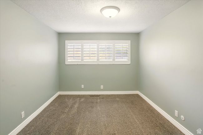 Carpeted spare room with a textured ceiling and baseboards | Image 15