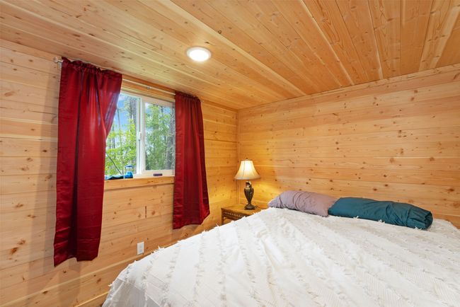 Bedroom featuring wood ceiling and wooden walls | Image 10