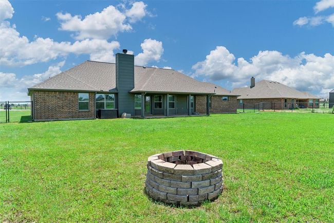 Rear view of property with a yard and an outdoor fire pit | Image 34