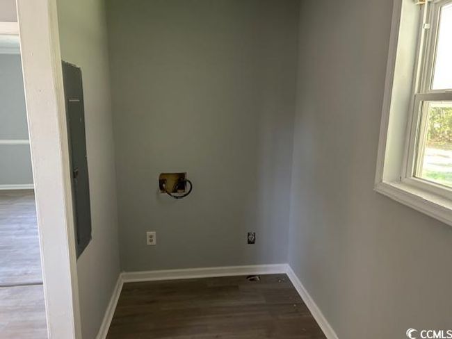 Washroom featuring hookup for a washing machine, wood finished floors, and baseboards | Image 17