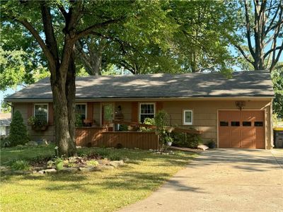 Ranch-style house with a garage and a front yard | Image 2