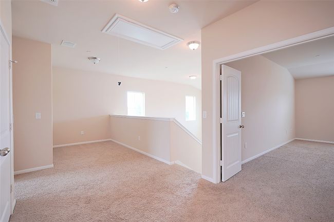 Carpeted spare room with attic access and baseboards | Image 10