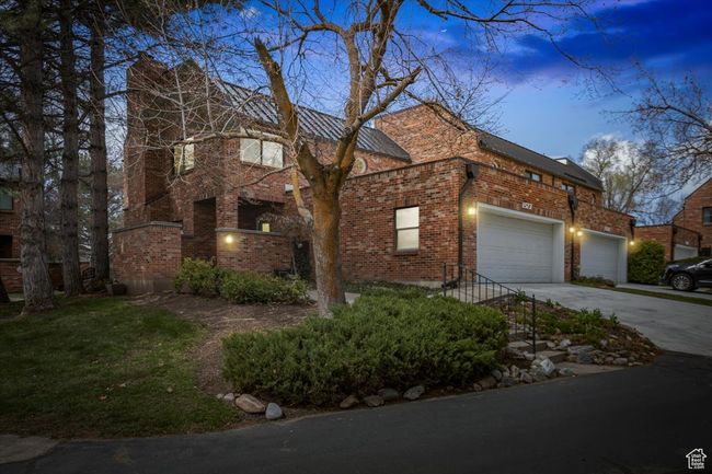 View of front of property with an attached garage, brick siding, and concrete driveway | Image 36