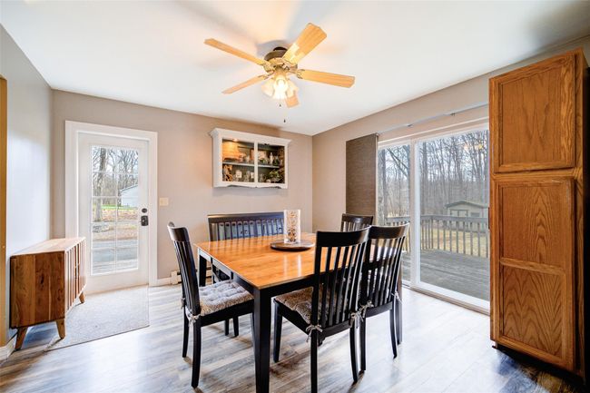 Dining space with a ceiling fan, light wood-style flooring, and plenty of natural light | Image 10