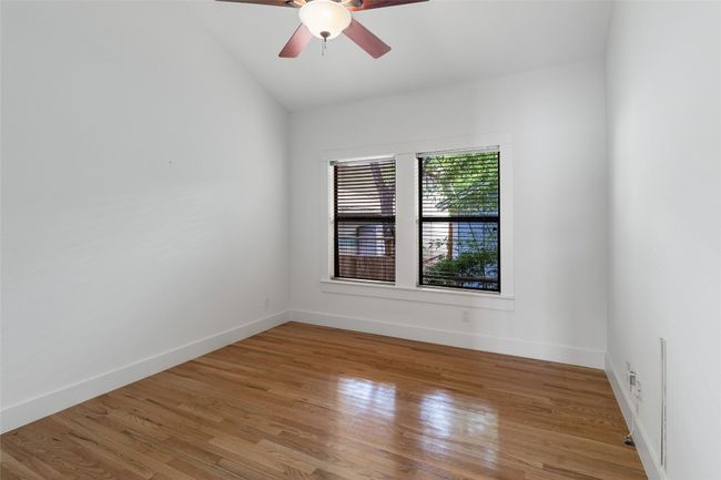 Unfurnished room with lofted ceiling, light wood finished floors, baseboards, and ceiling fan | Image 23