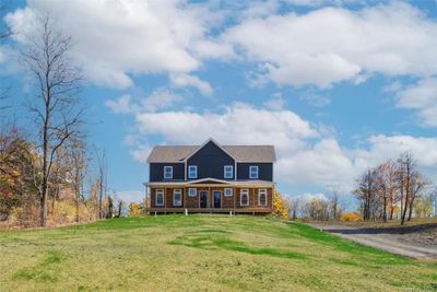 View of front of house with covered porch and a front yard | Image 1