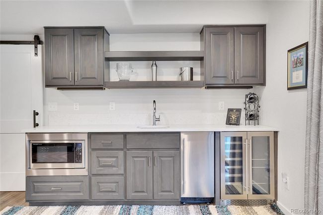 Wet bar with ice maker, frig, and microwave | Image 38