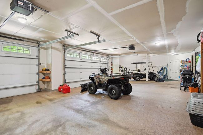 The extra large 3-car garage has additional space for toys and convenient storage. The heated floor is a huge bonus in the winter. | Image 23