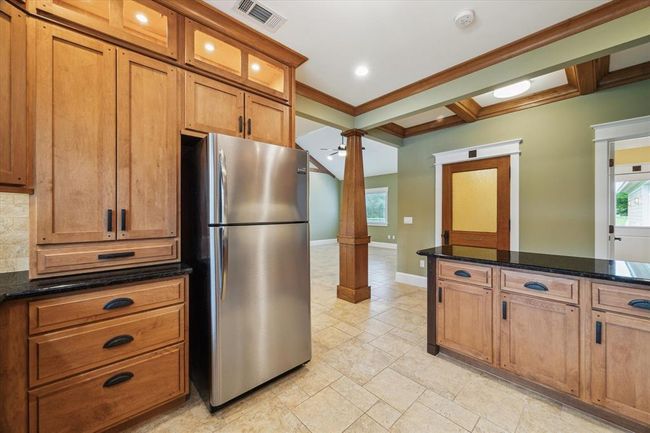THE KITCHEN IS WRAPPED IN CUSTOM CABINETS THOUGHTFULLY DESIGNED TO OFFER AN ABUNDANT STORAGE WITH SPECIALIZED COMPARTMENTS FOR POTS, PANS, AND DISHES OF ALL SHAPES AND SIZES. | Image 17