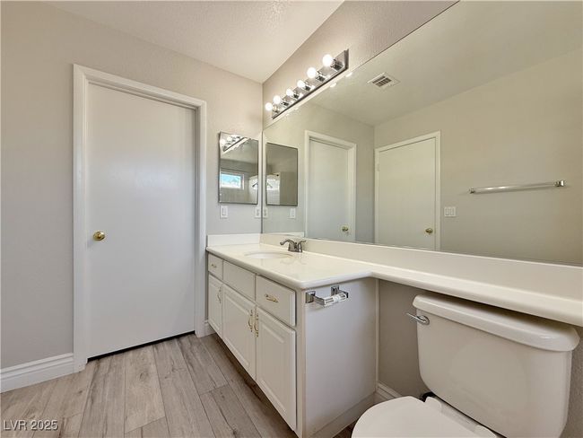 Bathroom with vanity, toilet, and wood finished floors | Image 30
