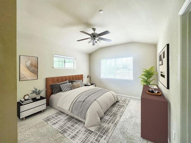 Carpeted bedroom with vaulted ceiling, ceiling fan, and baseboards | Image 11