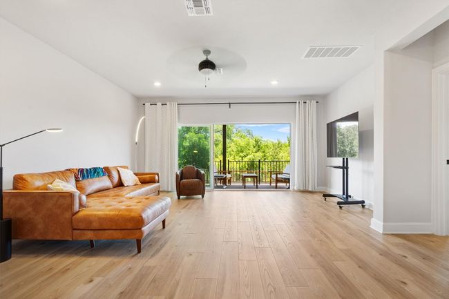 Living room with light wood-style flooring, plenty of natural light, recessed lighting, and baseboards | Image 8