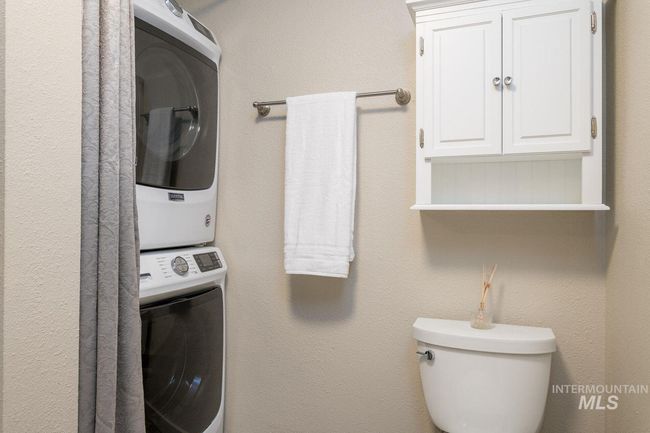 Laundry room featuring estacked washer and dryer | Image 11