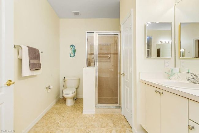 Full bath featuring a stall shower, visible vents, toilet, and vanity | Image 17