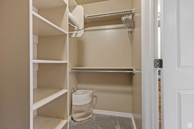 Walk in closet with carpet floors | Image 14