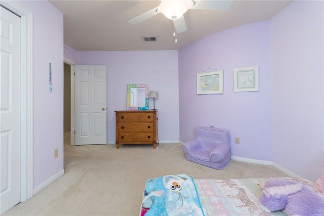 Bedroom with carpet flooring and a ceiling fan | Image 20