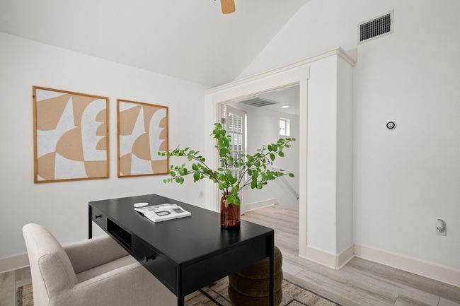 Office space with light wood finished floors, vaulted ceiling, baseboards, and a ceiling fan | Image 12