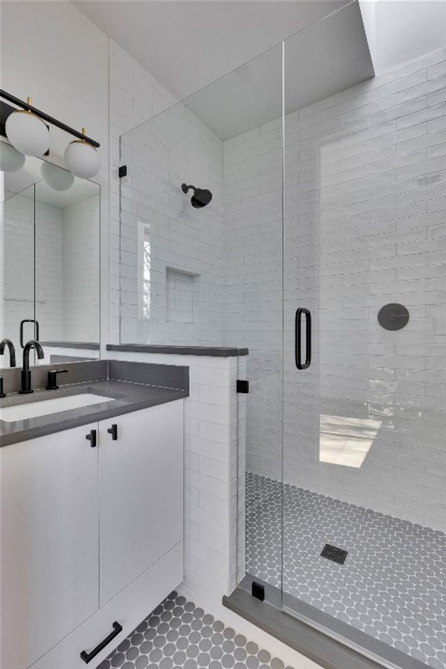 Bathroom featuring a shower stall and vanity | Image 14